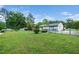 Large backyard featuring lush lawn, a covered gazebo, and a detached garage at 206 Lane Of Tristram, Garner, NC 27529