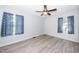 Cozy bedroom with light-gray walls, modern flooring, a ceiling fan, and well-lit windows at 206 Lane Of Tristram, Garner, NC 27529