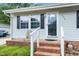 Close-up of the front porch with brick steps, white railing, and charming details at 206 Lane Of Tristram, Garner, NC 27529