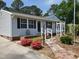 Close up of a quaint house with stone pavers, colorful landscaping, and a welcoming front entrance at 206 Lane Of Tristram, Garner, NC 27529