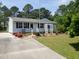 Neat single-story home featuring vinyl siding, dark shutters, and a well-maintained lawn with landscaping at 206 Lane Of Tristram, Garner, NC 27529
