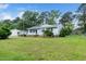 Spacious front yard featuring a charming one-story home with well-maintained lawn and mature trees at 206 Lane Of Tristram, Garner, NC 27529