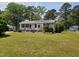 Charming single-story home with a well-manicured lawn, mature trees, and a welcoming front porch at 206 Lane Of Tristram, Garner, NC 27529
