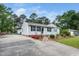 Charming one-story home with light gray siding, black shutters, and a well-manicured front yard with mature trees at 206 Lane Of Tristram, Garner, NC 27529