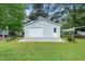 Detached garage with lush lawn in the backyard, with an additional carport at 206 Lane Of Tristram, Garner, NC 27529