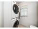 Efficient laundry area with stacked washer and dryer, and a window with light-colored curtains at 206 Lane Of Tristram, Garner, NC 27529
