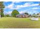 Spacious backyard with a gazebo, lush lawn, and a red brick home with white trim at 208 E Harrington Ave, Broadway, NC 27505