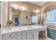 Well-lit bathroom with a wide vanity, decorative backsplash, and an open view to the bedroom at 208 E Harrington Ave, Broadway, NC 27505