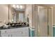 Functional bathroom with a vanity, framed mirror, frosted glass shower door, and neutral decor at 208 E Harrington Ave, Broadway, NC 27505