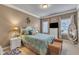 Cozy bedroom features charming decor, a plush bed, and soft lighting for a relaxing ambiance at 208 E Harrington Ave, Broadway, NC 27505