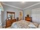 Cozy bedroom with a colorful quilt, wooden dressers, and ample closet space for storage at 208 E Harrington Ave, Broadway, NC 27505