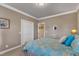 Bright bedroom features a well-lit closet, plush blue pillows, and neutral color scheme at 208 E Harrington Ave, Broadway, NC 27505