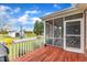 Beautiful wood deck overlooks a spacious yard with a screened-in porch attached to home at 208 E Harrington Ave, Broadway, NC 27505