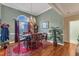 Elegant dining room with chandelier, table set for six, and a large window providing natural light at 208 E Harrington Ave, Broadway, NC 27505