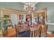 Dining room with hardwood floors, a chandelier, and multiple entry points to other rooms at 208 E Harrington Ave, Broadway, NC 27505