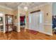 Inviting foyer featuring hardwood floors, elegant lighting, and an open entryway to the living spaces at 208 E Harrington Ave, Broadway, NC 27505