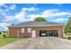 Spacious brick garage featuring an open door, parking for a vehicle, and a well-maintained exterior at 208 E Harrington Ave, Broadway, NC 27505