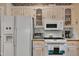 Kitchen featuring white appliances, cabinets with glass accents, and a built-in microwave and oven at 208 E Harrington Ave, Broadway, NC 27505