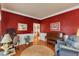 Living room with hardwood floors, a piano, and a view into adjacent living spaces at 208 E Harrington Ave, Broadway, NC 27505