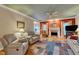 Cozy living room with a fireplace, comfortable seating, ceiling fan, and hardwood floors at 208 E Harrington Ave, Broadway, NC 27505