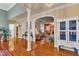 Open-concept living area with hardwood floors, arched doorway, and view of the fireplace at 208 E Harrington Ave, Broadway, NC 27505