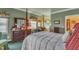 Bright bedroom featuring a dresser, window seat, and a mural in the adjacent sunroom at 208 E Harrington Ave, Broadway, NC 27505