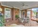 Charming covered patio with brick flooring, a ceiling fan, and comfortable seating for outdoor enjoyment at 208 E Harrington Ave, Broadway, NC 27505