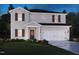 Charming two-story home with a well-manicured lawn, covered entryway, and attached two car garage at 2227 Cherry Creek Rd, Haw River, NC 27258