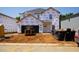 Exterior view of a home under construction with Tyvek wrap and heavy equipment at 2233 Cherry Creek Rd, Haw River, NC 27258