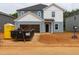 Two-story home with blue siding, white accents, and an open garage, presenting a classic, clean, and inviting facade at 2233 Cherry Creek Rd, Haw River, NC 27258