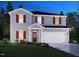 Newly constructed home with gray siding, red shutters, and a two-car garage at 2239 Cherry Creek Rd, Haw River, NC 27258