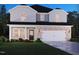 Charming home featuring a brick facade, an attached two-car garage, and manicured landscaping at 2251 Cherry Creek Rd, Haw River, NC 27258