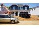 New construction home featuring a blue two-story facade and construction equipment on a sunny day at 2251 Cherry Creek Rd, Haw River, NC 27258