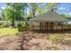 Fenced-in backyard with storage shed and lush green backdrop provides privacy at 2343 Derby Dr, Raleigh, NC 27610