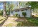 A charming single-story house with a brick facade and mature trees in the front yard at 2343 Derby Dr, Raleigh, NC 27610