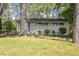 Charming single-story home with brick accents, mature trees, and lush greenery at 2343 Derby Dr, Raleigh, NC 27610