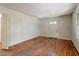 Spacious, empty living room with hardwood floors, white walls, and ample natural light at 2343 Derby Dr, Raleigh, NC 27610