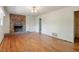 Spacious living room with hardwood floors and brick fireplace at 2343 Derby Dr, Raleigh, NC 27610