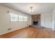 Bright living room featuring hardwood floors, fireplace, and natural light at 2343 Derby Dr, Raleigh, NC 27610
