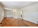 An empty living room with hardwood floors and white walls ready for updates at 2343 Derby Dr, Raleigh, NC 27610