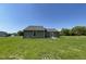 Back exterior of a home on a large lawn at 261 Phil Jack Rd, Dunn, NC 28334