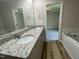 A bathroom with double sink vanity with granite countertops, and wood look floors at 261 Phil Jack Rd, Dunn, NC 28334