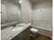 Clean bathroom with white countertops, a large mirror, and a shower-tub combination at 261 Phil Jack Rd, Dunn, NC 28334