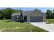 New construction home featuring a two-car garage, neutral siding, and a well-manicured lawn at 261 Phil Jack Rd, Dunn, NC 28334