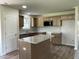 Well-lit kitchen featuring an island, wood cabinets, granite countertops, and stainless steel appliances at 261 Phil Jack Rd, Dunn, NC 28334