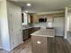 Spacious kitchen featuring an island, wood cabinets, granite countertops, and stainless steel appliances at 261 Phil Jack Rd, Dunn, NC 28334