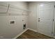 Clean and functional laundry room with shelving, washer/dryer hookups, and wood-style flooring at 261 Phil Jack Rd, Dunn, NC 28334