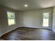 Brightly lit bonus room with wood-style flooring and a glass paneled door leading outside at 261 Phil Jack Rd, Dunn, NC 28334