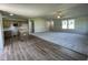 Spacious living room with plush carpeting, a ceiling fan, and an adjacent kitchen area at 261 Phil Jack Rd, Dunn, NC 28334