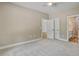 Carpeted bedroom featuring a ceiling fan and doorways to the main living area and a bathroom at 2820 Tara Dr, Clayton, NC 27520